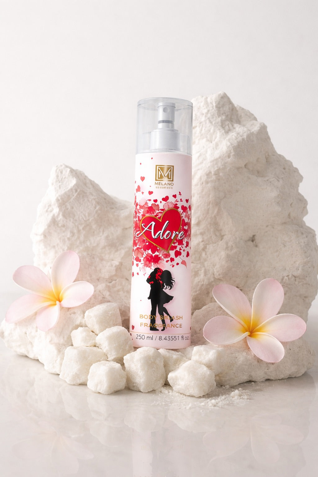 Melano Body splash adore
 product bottle with decorative elements on a white background